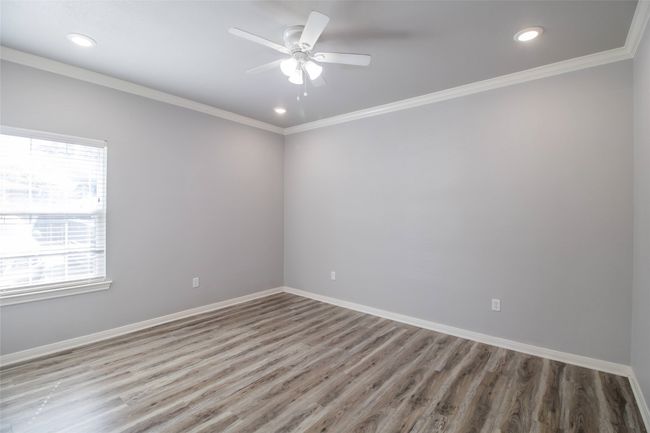 Spare room featuring wood finished floors, crown molding, ceiling fan, and recessed lighting | Image 11