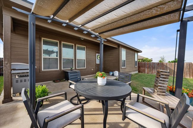 View of patio featuring outdoor dining space, a pergola, fence, and area for grilling | Image 32