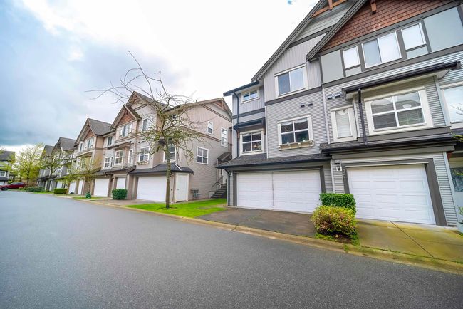 View of front of house with driveway, a residential view, and a garage | Image 37
