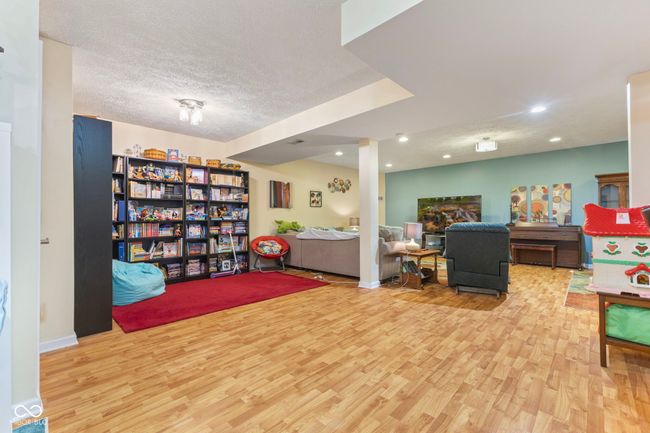 sitting room with wood finished floors, recessed lighting, and a textured ceiling | Image 29
