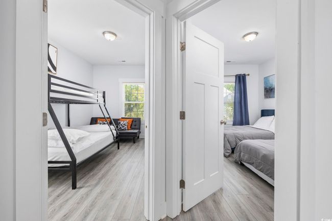 Bedroom featuring multiple windows and light wood-style flooring | Image 17