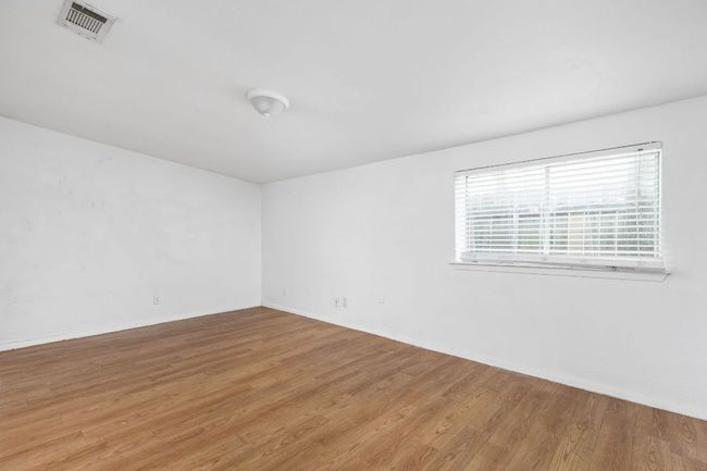 Empty room with visible vents, baseboards, and light wood finished floors | Image 36