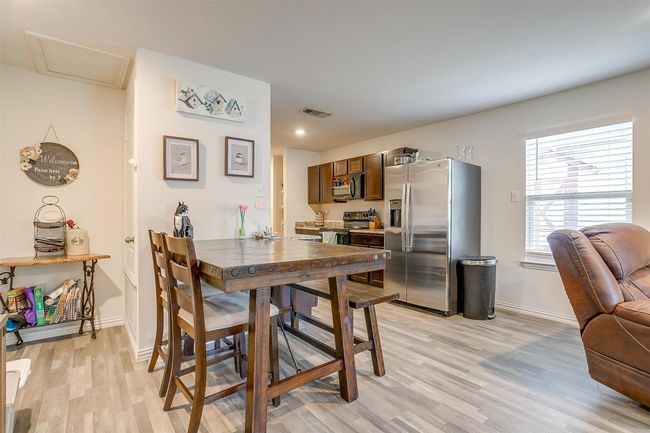 Dining space featuring vinyl flooring and baseboards | Image 9