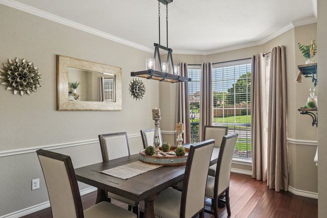 Beautiful dining area with engineered bamboo flooring and upgraded lighting. | Image 4
