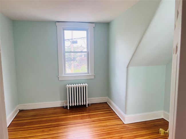 Bonus room featuring radiator heating unit and light wood finished floors | Image 12