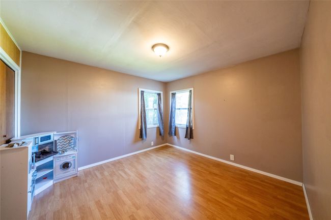 Empty room with light wood finished floors and baseboards | Image 15