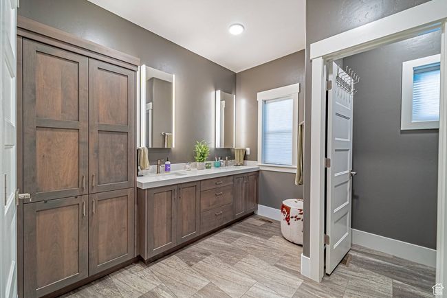 Primary bathroom with double vanity and baseboards | Image 7