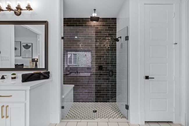 Bathroom with walk in shower, tile patterned floors, and vanity | Image 23
