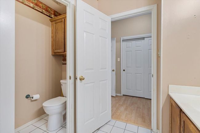 Bathroom featuring tile patterned flooring, toilet, vanity, and baseboards | Image 23
