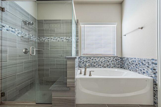 Full bath featuring a garden tub and a stall shower | Image 21