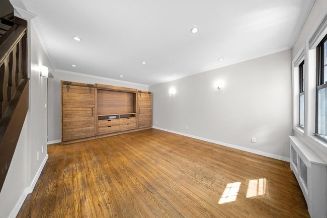 Unfurnished living room featuring crown molding, wood finished floors, baseboards, and recessed lighting | Image 16