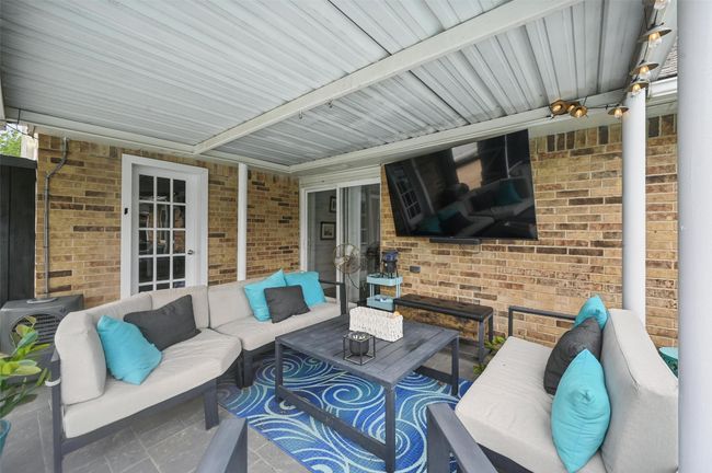 View of patio with an outdoor hangout area | Image 29