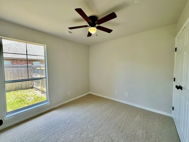 Empty room featuring a ceiling fan, carpet, and a smoke detector | Image 14