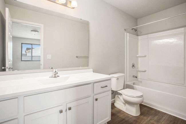 The primary suite includes a private bath and an oversized walk-in closet with a front facing exterior window to optimize natural lighting. | Image 13