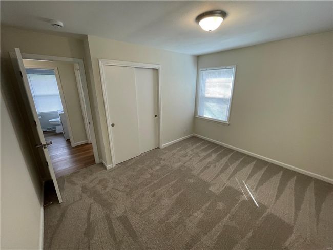 Unfurnished bedroom with baseboards, carpet floors, and a closet | Image 29