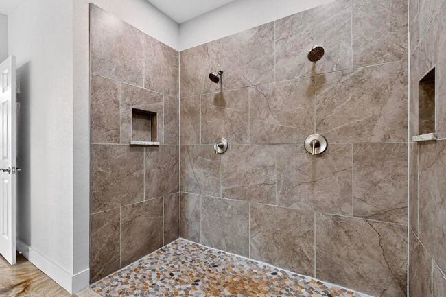 Full bathroom featuring tiled shower and baseboards | Image 31