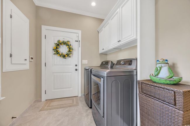 Washroom with independent washer and dryer, cabinet space, light marble finish floors, recessed lighting, and baseboards | Image 17