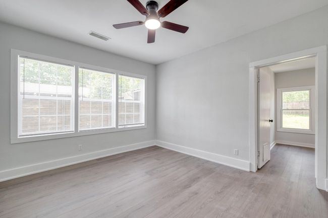 Spare room with ceiling fan, light wood-style flooring, and plenty of natural light | Image 13