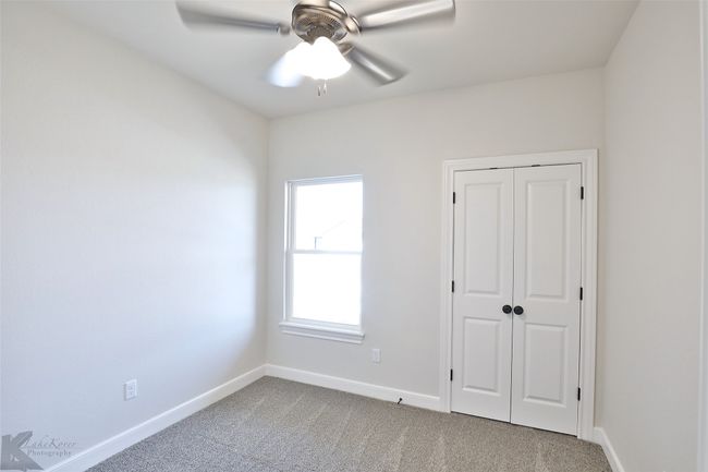 Unfurnished bedroom with carpet flooring, a closet, and a ceiling fan | Image 20