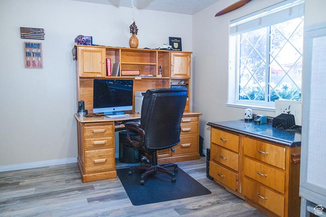 Home office featuring light wood-style flooring | Image 19