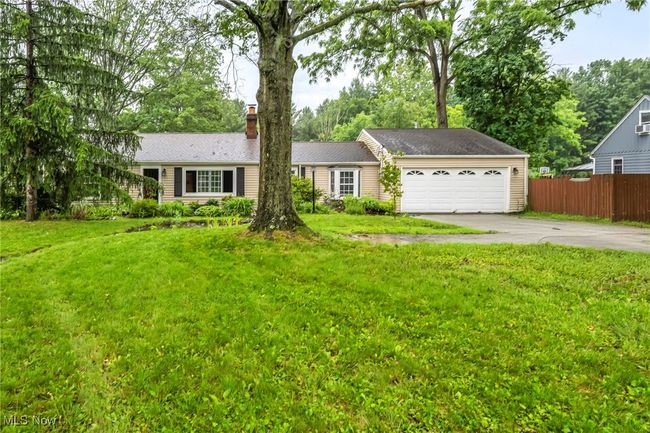 Virtually staged. Ranch-style home featuring concrete driveway, a garage, and a chimney | Image 31