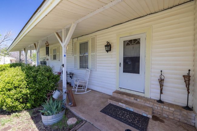 Doorway to property featuring covered porch | Image 5