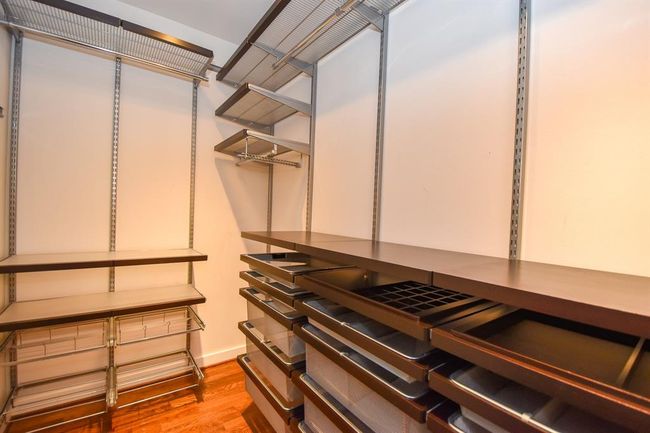 Another view of the walk-in closet, showcasing shelving and hanging space. This spacious and well-organized closet provides ample storage, making it easy to keep everything neatly arranged. | Image 30