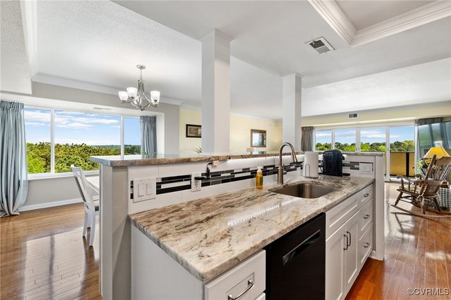 Kitchen with a sink, hardwood / wood-style floors, white cabinetry, ornamental molding, and dishwasher | Image 10