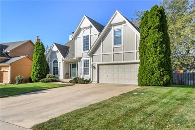 View of front of property with a garage and a front lawn | Image 1