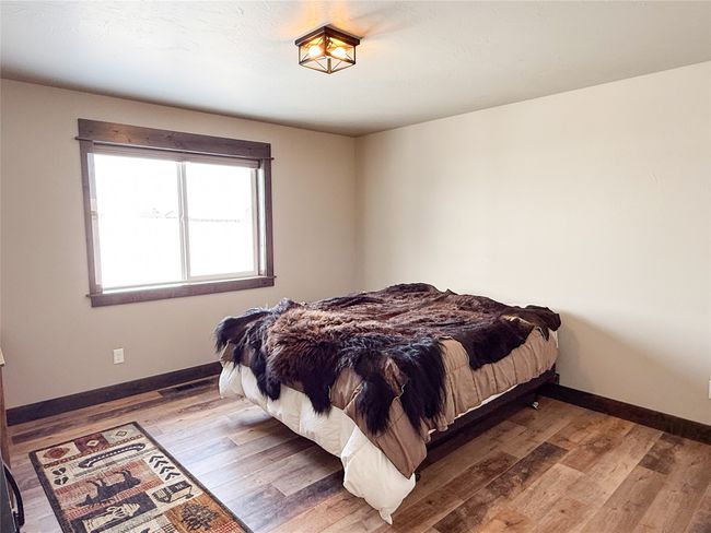 Bedroom with hardwood / wood-style flooring and baseboards | Image 29