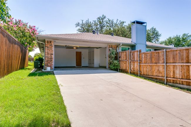 Rear entry garage with view of fence with steel posts. | Image 23