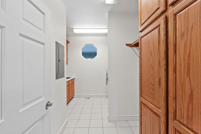 Main level laundry room w/ tile flooring | Image 26