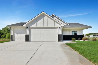 View of front of property with a front yard and a garage | Image 2