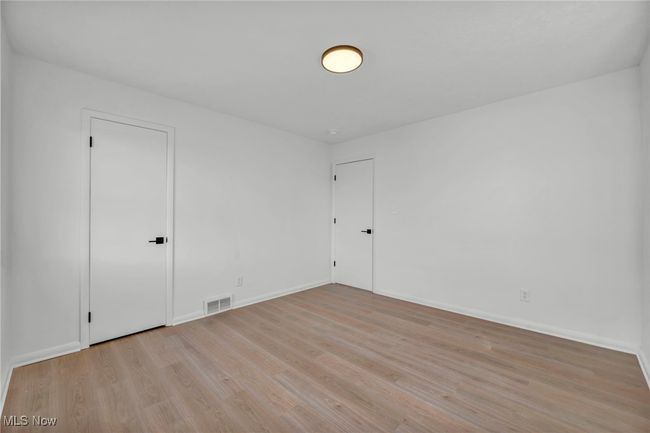 Spare room with light wood-style flooring, baseboards, and visible vents | Image 16
