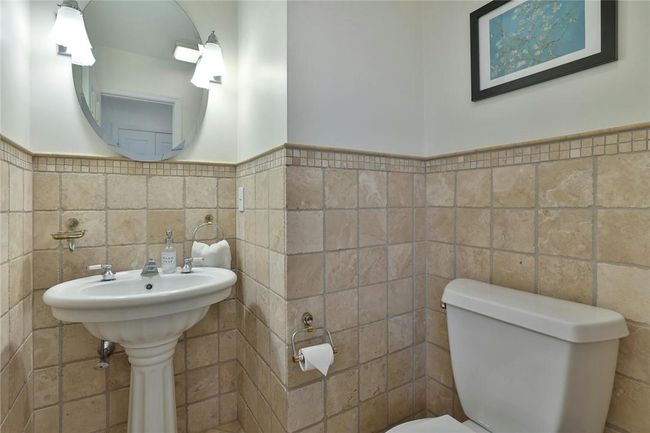 The Powder Room lies right off the first floor entry | Image 14