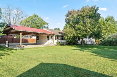 Big back yard, partially fenced, 2-Car Carport/Entertainment area perfect for family gatherings. | Image 2