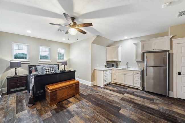 Upstairs, you'll find a private caregiver or guest suite, complete with a kitchenette for added convenience. Accessible from the main home or a separate back stairway, the suite also includes a walk-in closet and a full bathroom, offering comfort and privacy for guests or live-in caregivers. | Image 40