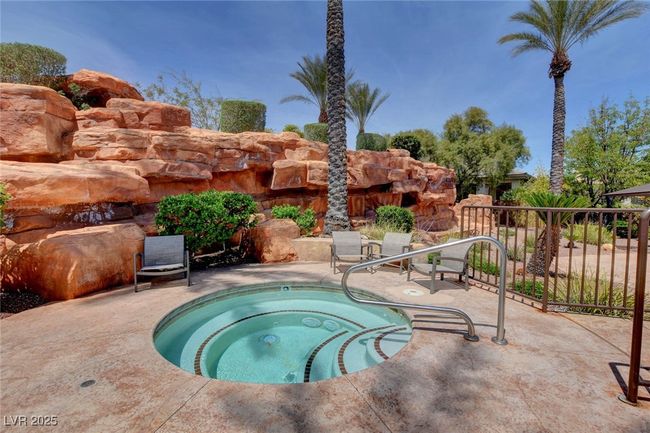 View of pool with an in ground hot tub and a patio area | Image 53