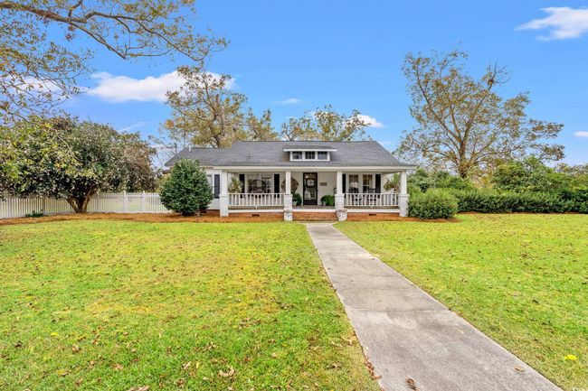 View of front facade featuring covered porch and concrete driveway | Image 24