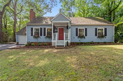 View of front facade with a garage and a front yard | Image 1