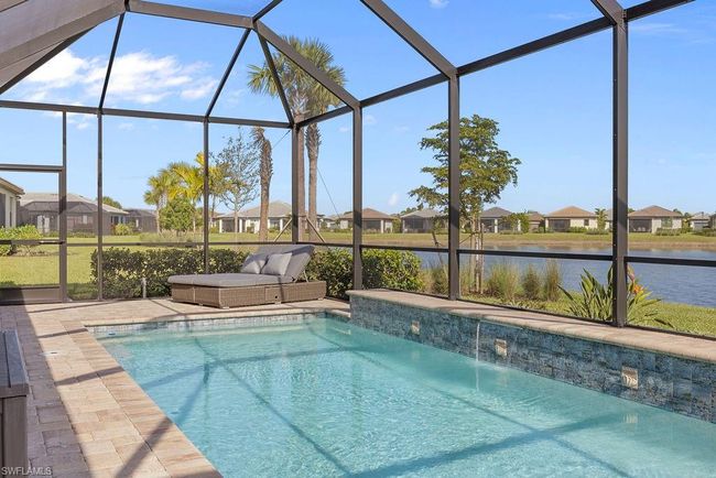 Pool with glass enclosure, a patio, and a water view | Image 41