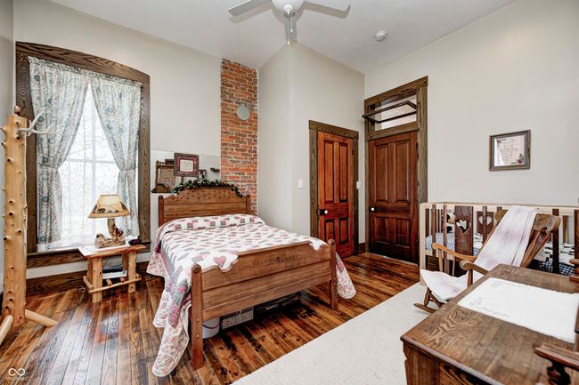 bedroom featuring wood-type flooring and a ceiling fan | Image 28