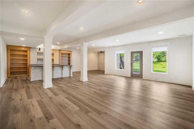 Unfurnished living room with decorative columns, wood finished floors, recessed lighting, and baseboards | Image 57