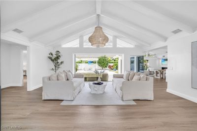 Living room with vaulted ceiling with beams and light hardwood / wood-style flooring | Image 2