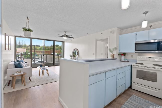 The living room and kitchen area seamlessly connect. Updated with modern touches. | Image 5