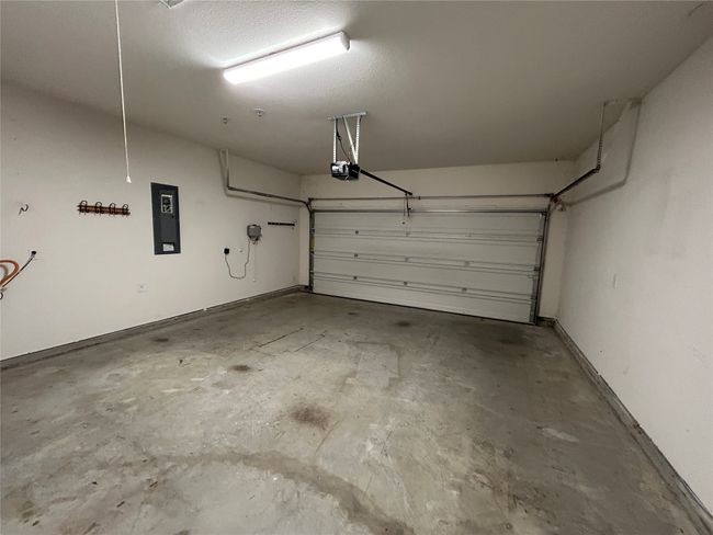 Garage with electric panel and a garage door opener | Image 25