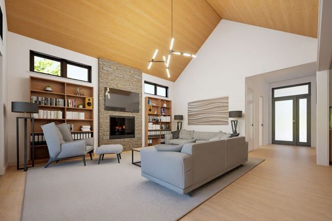 Spacious great room featuring a soaring vaulted wood ceiling and a stunning gas fireplace with a stone surround. | Image 6