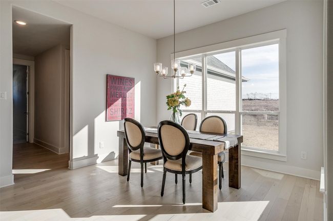 Dining room featuring a chandelier and light hardwood / wood-style floors | Image 18