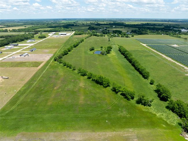 Aerial view of sparsely populated area featuring extensive farmland | Image 7