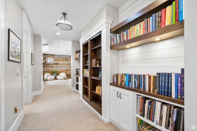 Hall featuring wood walls, carpet, and baseboards | Image 51